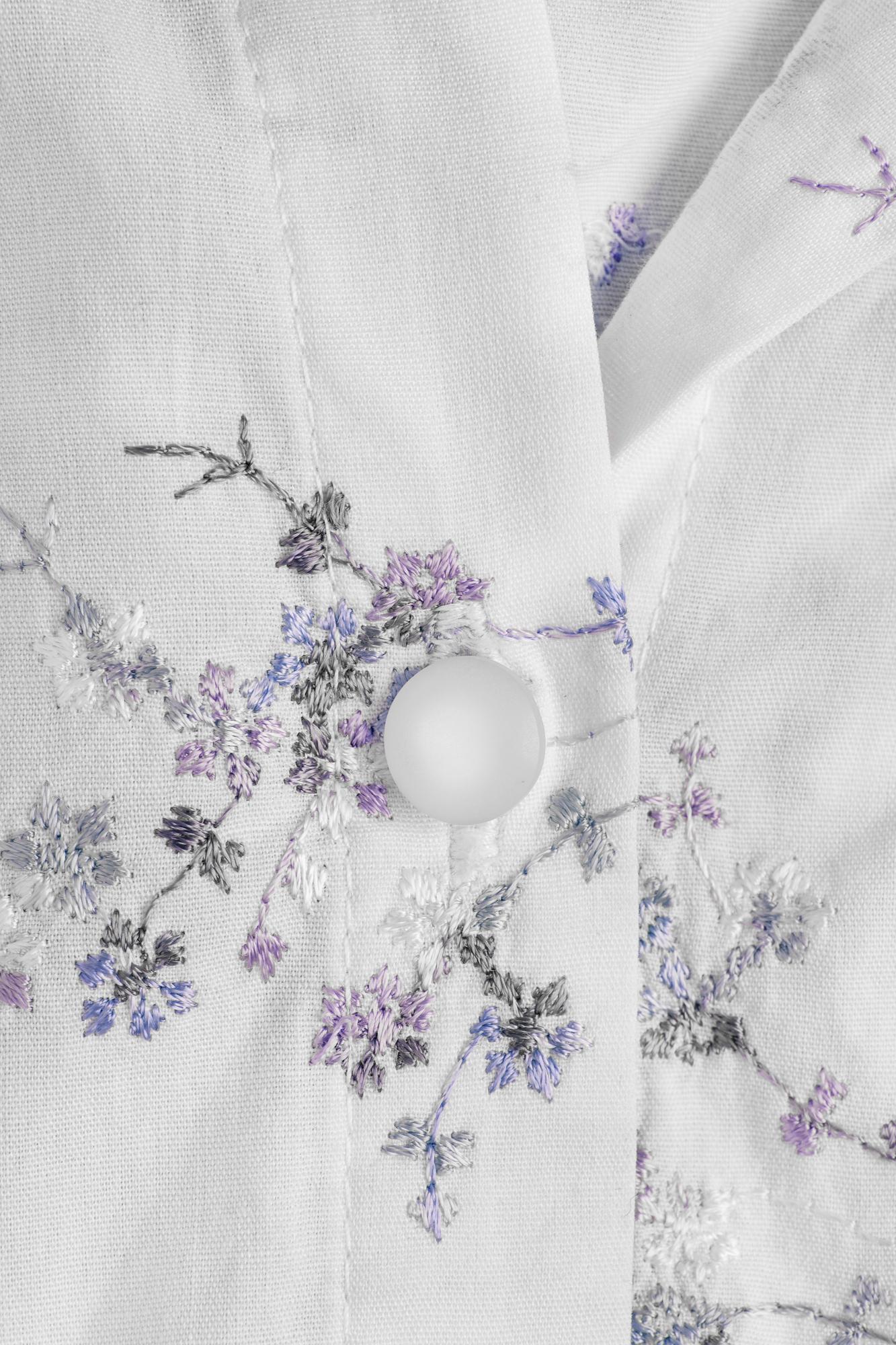Close-up of embroidered floral pattern on linen